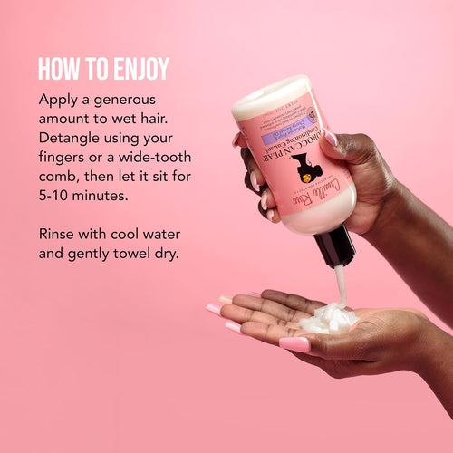 Woman applying Moroccan Pear Hair Custard Hydrating Curl Conditioner to curly hair